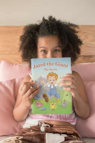 African-American little girl holding children's book Jared the Giant by Sharon Aubrey